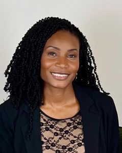 Smiling woman with long black hair, wearing black blazer