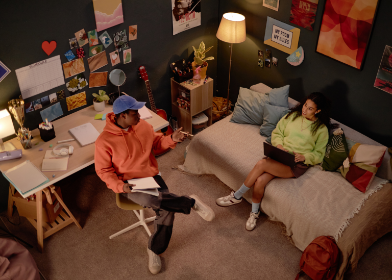 Young man & woman studying in dorm room