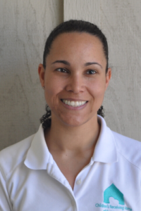 Professional Staff headshot. A woman with hair pulled back smiling at the camera.
