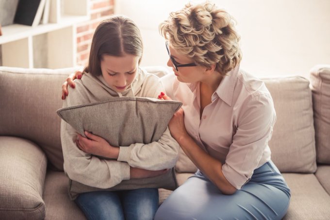 adult comforting upset teen