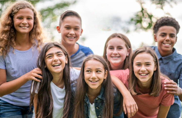 group of smiling 12-14 year olds
